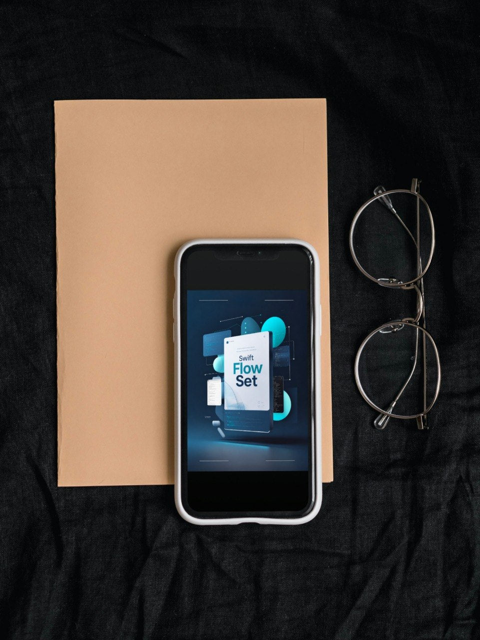 A smartphone lying on a tan paper sheet over a black fabric surface, with eyeglasses to the right. The phone screen displays the Vertex Link logo.